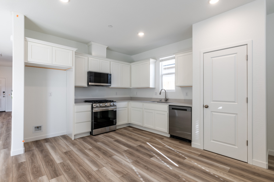 A kitchen with white cabinets.