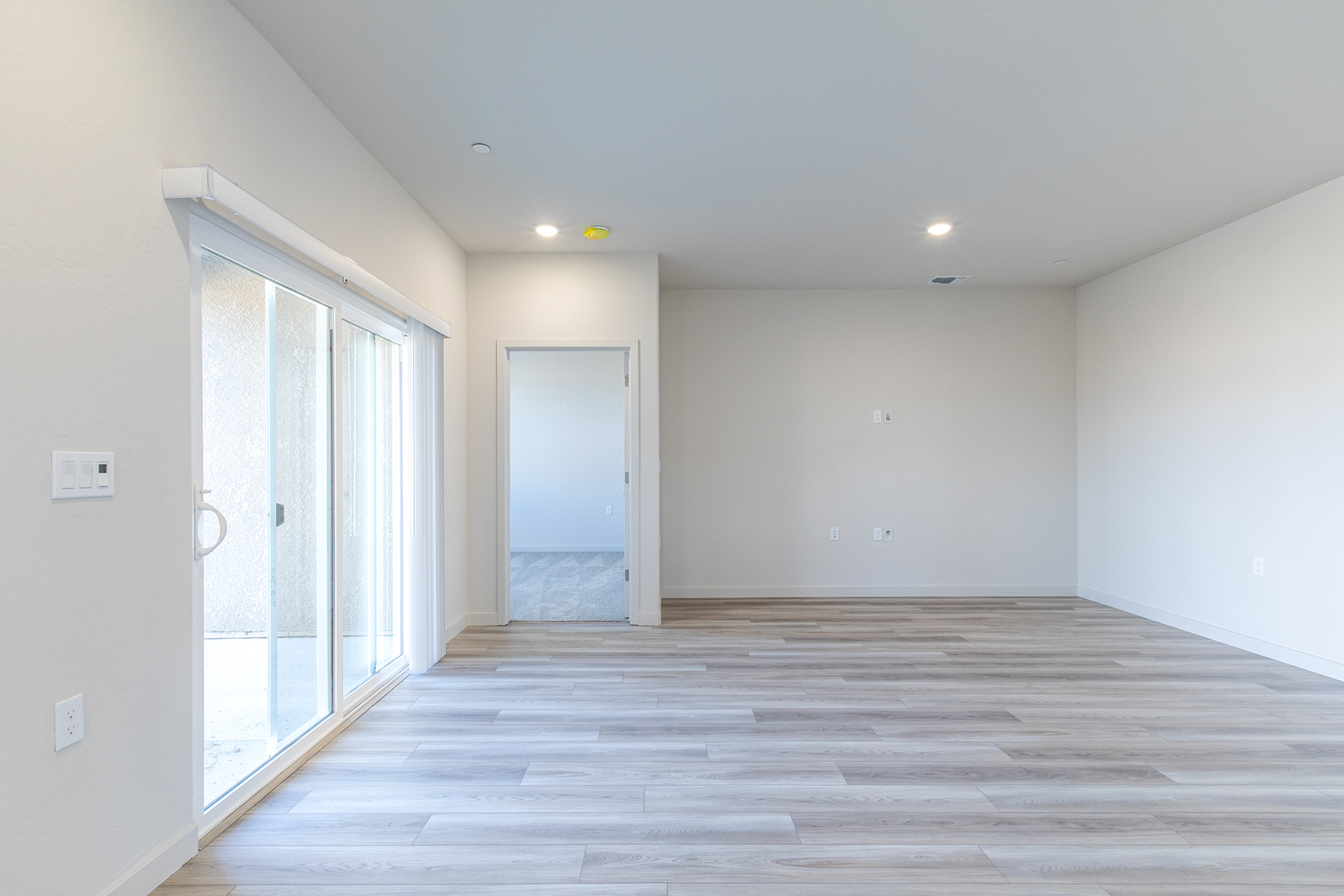 A room with a wood floor and white walls.