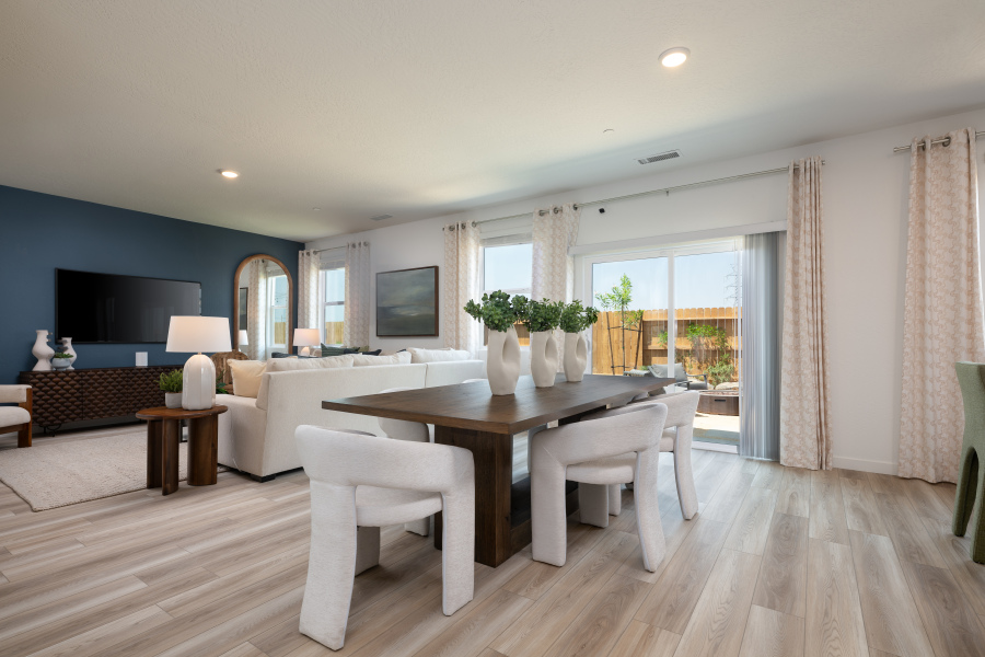 A large living room with a large table and chairs.