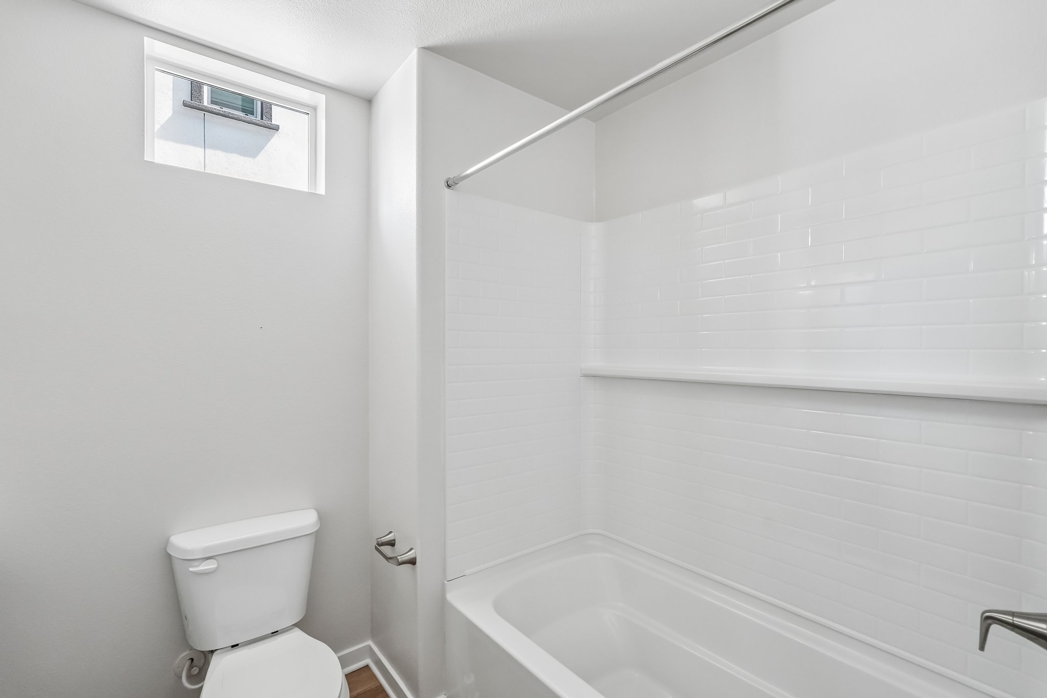 A bathroom with a tub toilet and sink.