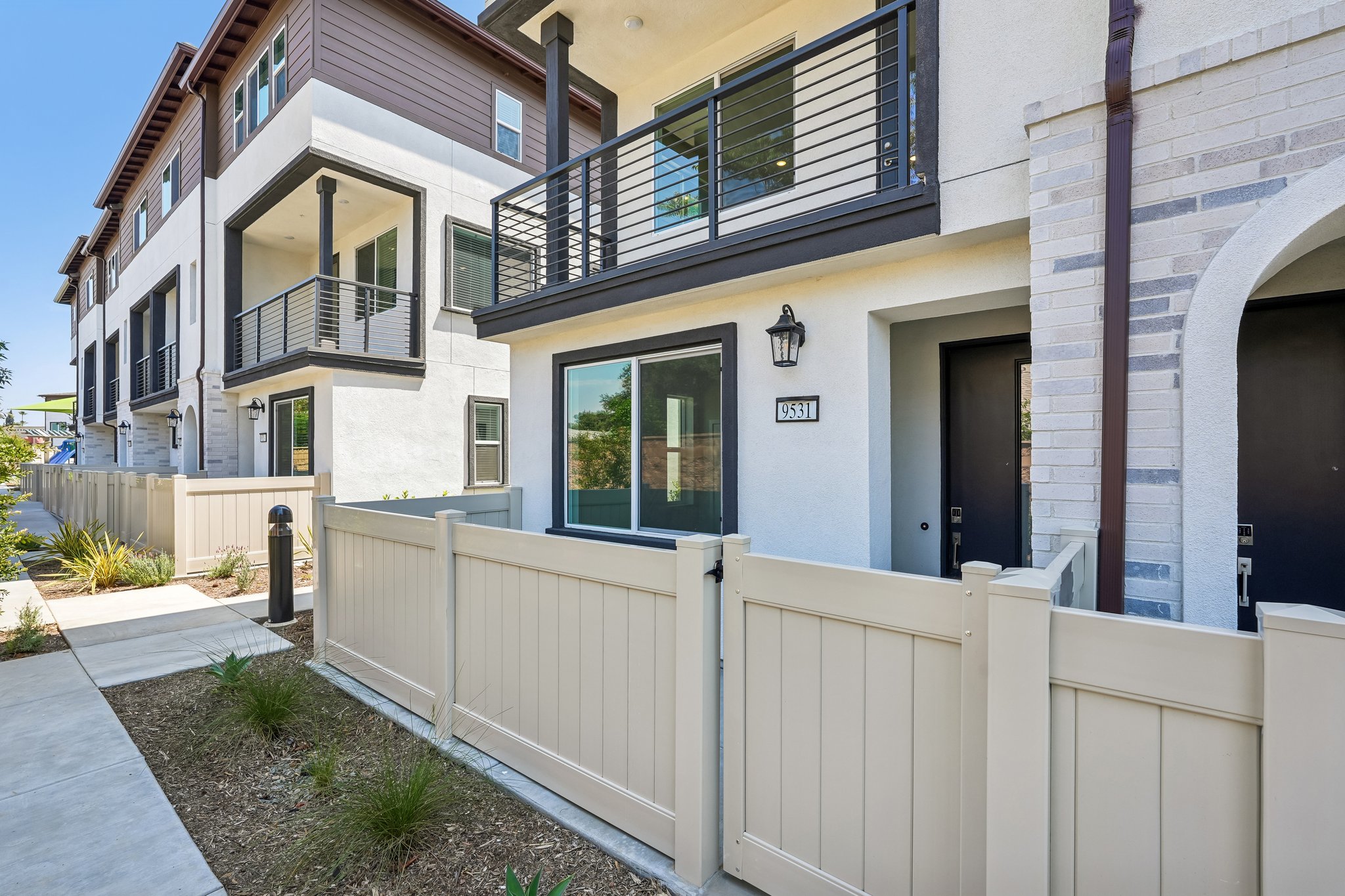 A white fence in front of a building.