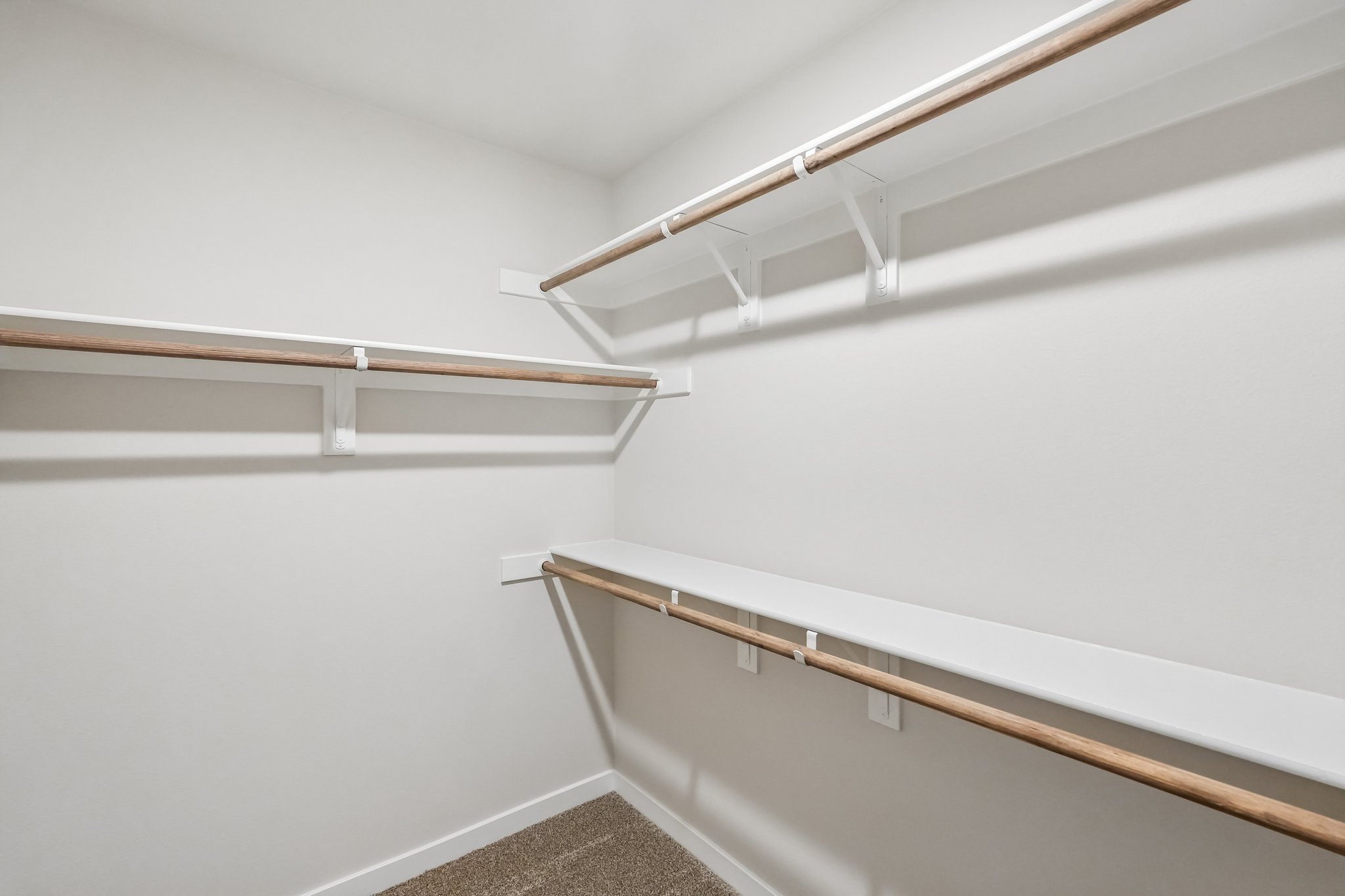 A white wall with a wooden railing.