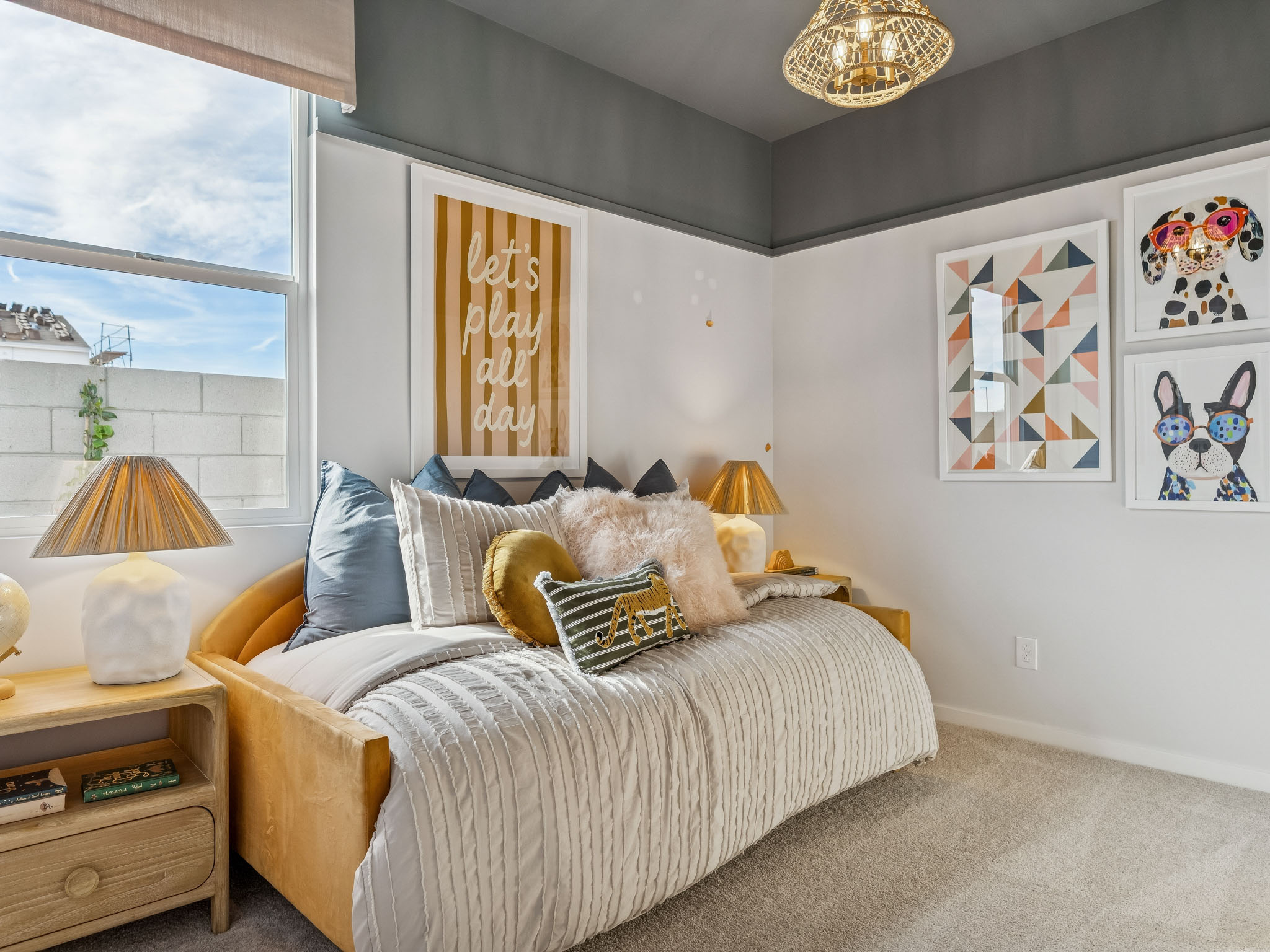 A bedroom with a bed and lamps.