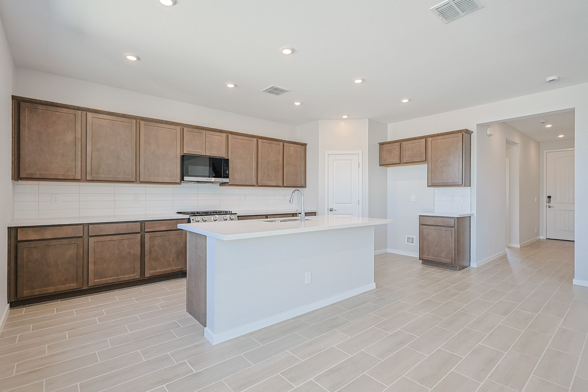 A kitchen with wooden cabinets.