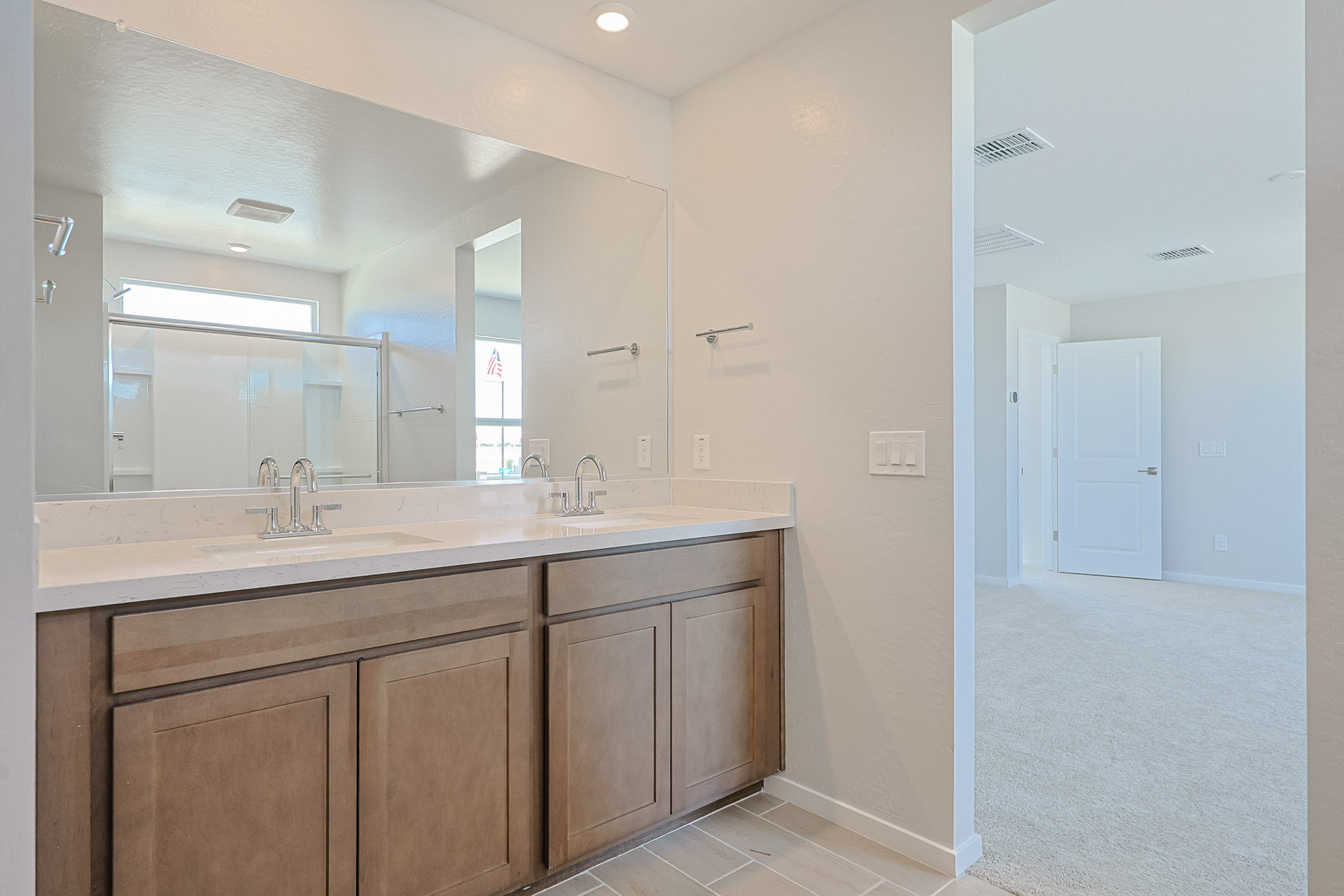 A bathroom with a large mirror.