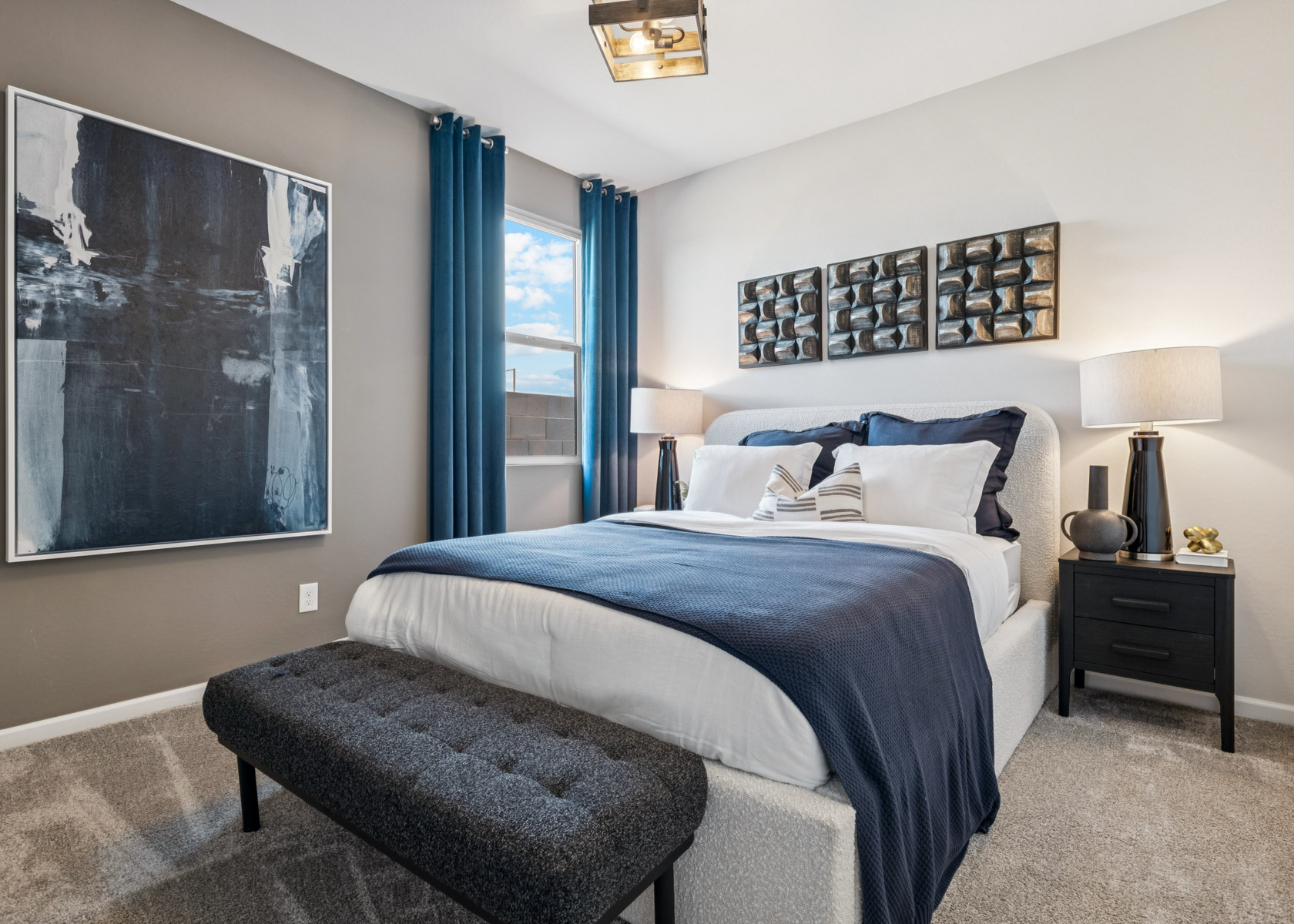 A bedroom with a bed and a bench.