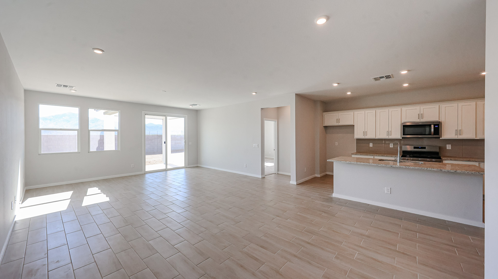 A large kitchen with white cabinets.