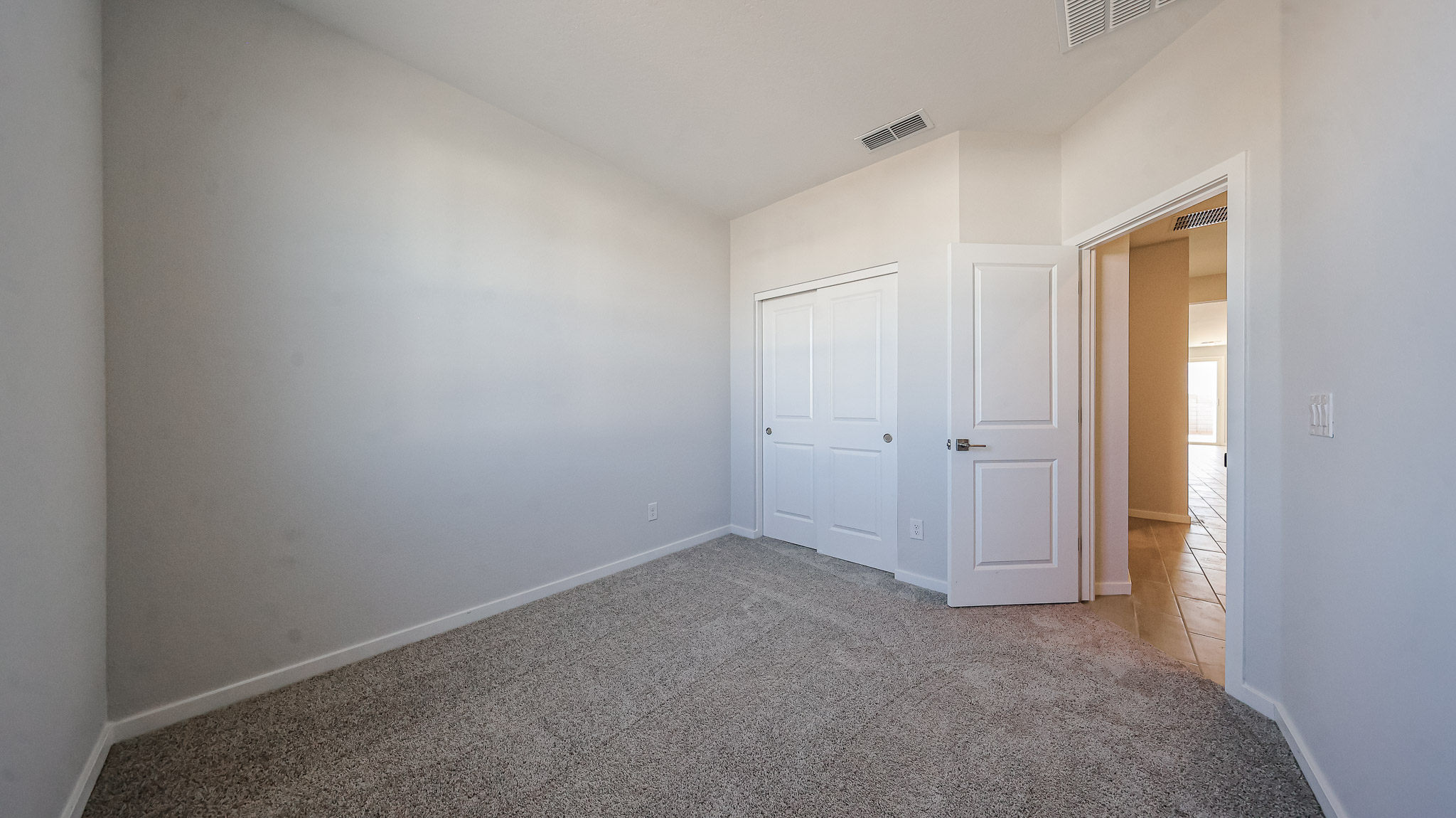 A hallway with white doors.
