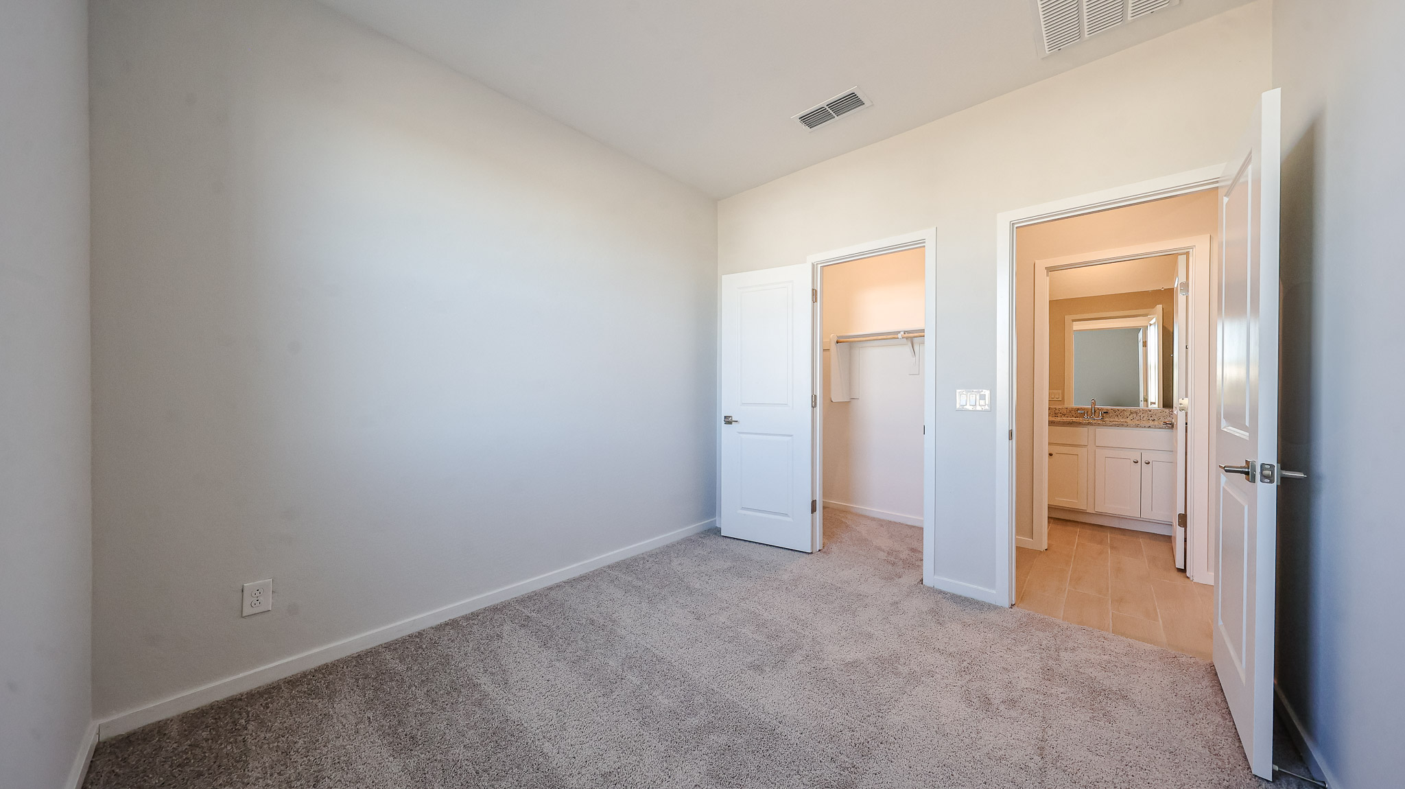 A hallway with white doors.