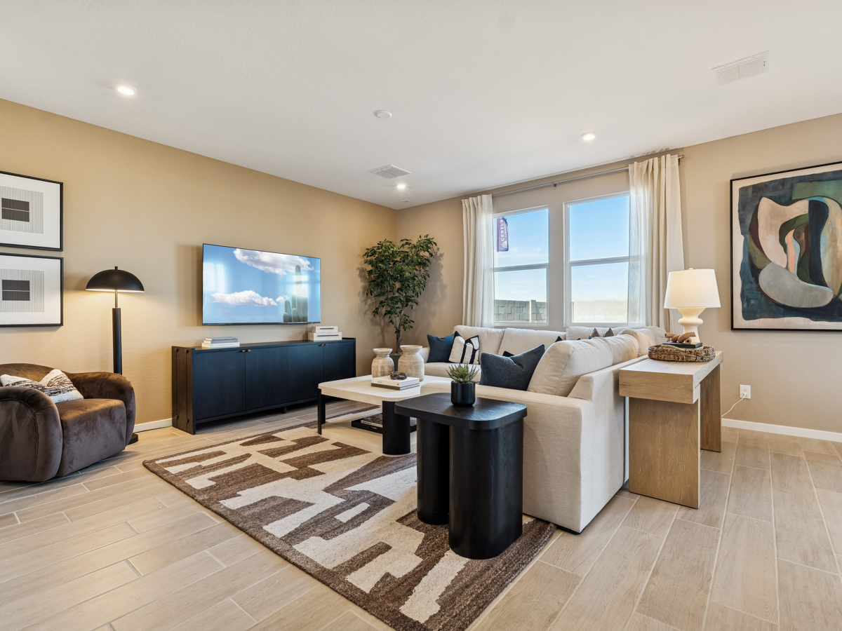 A living room with a large television.