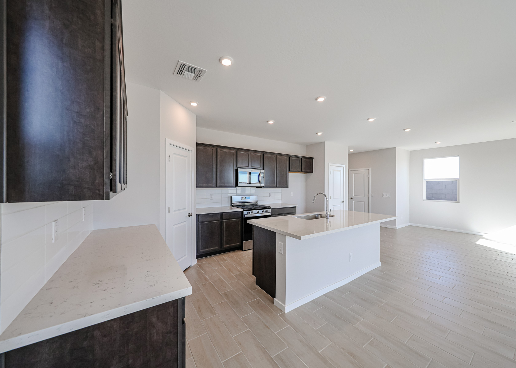 A kitchen with black cabinets.