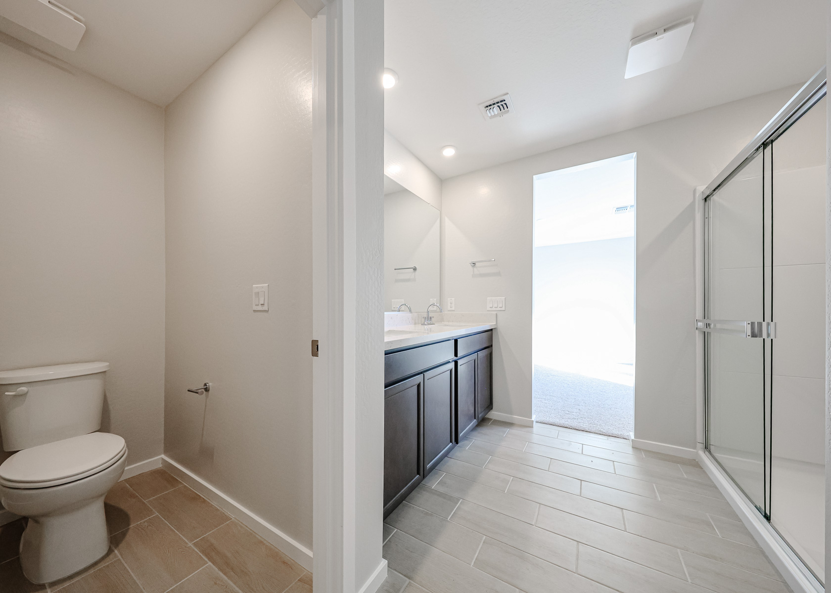 A bathroom with a shower and toilet.