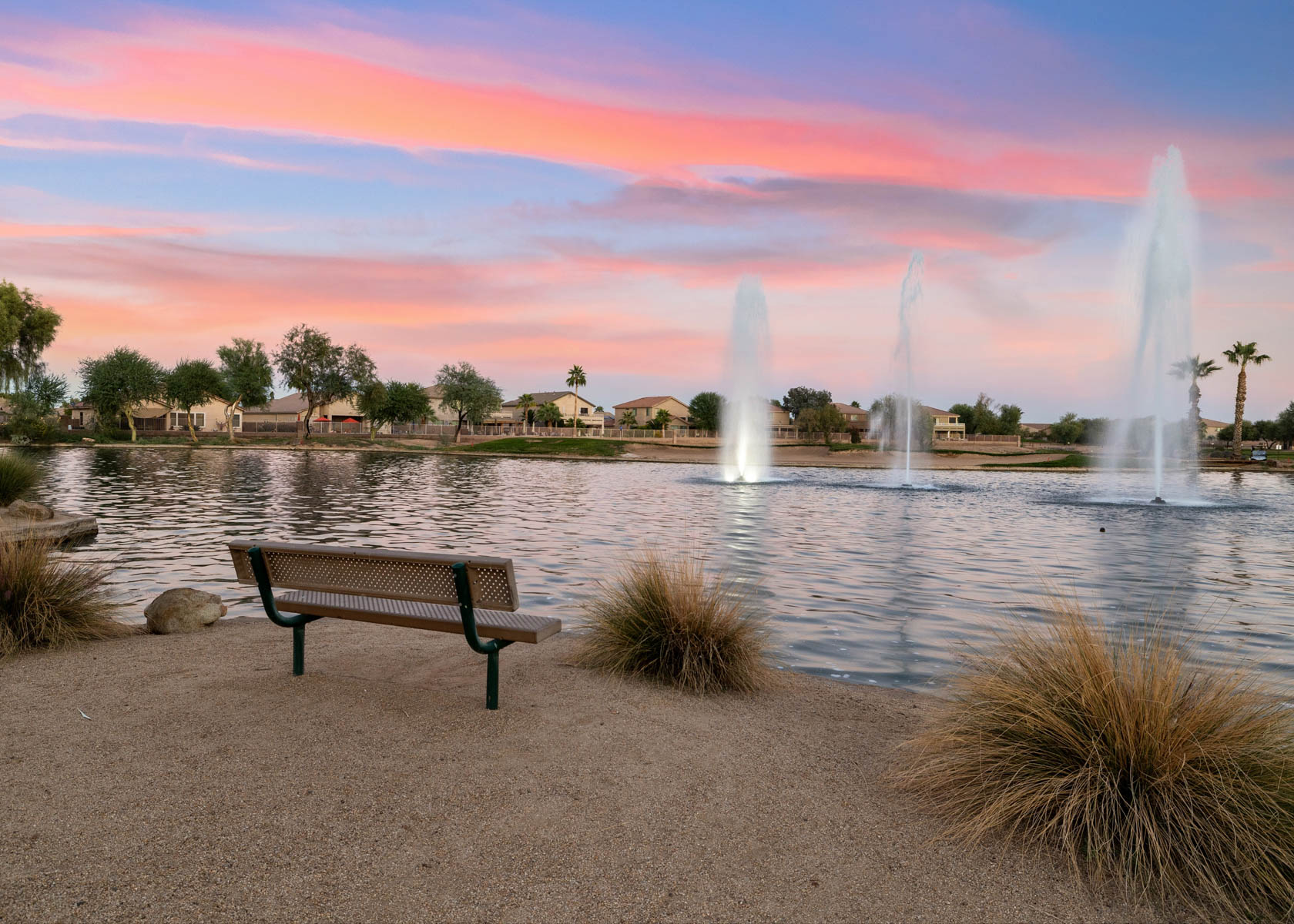 A bench next to a fountain.