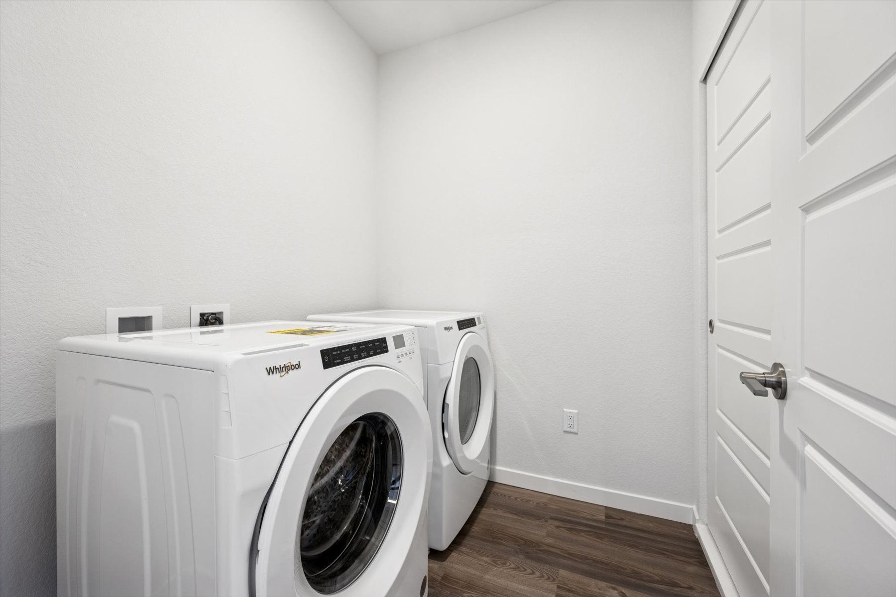 A white washing machine in a room.