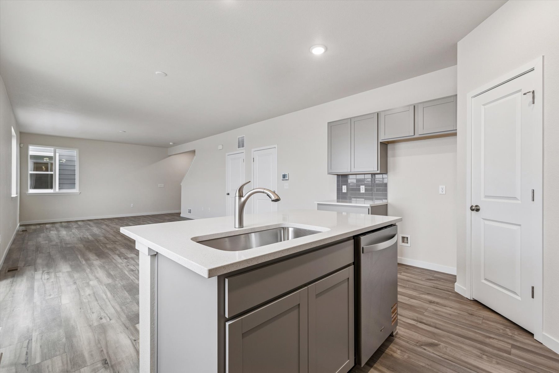 A kitchen with white cabinets.