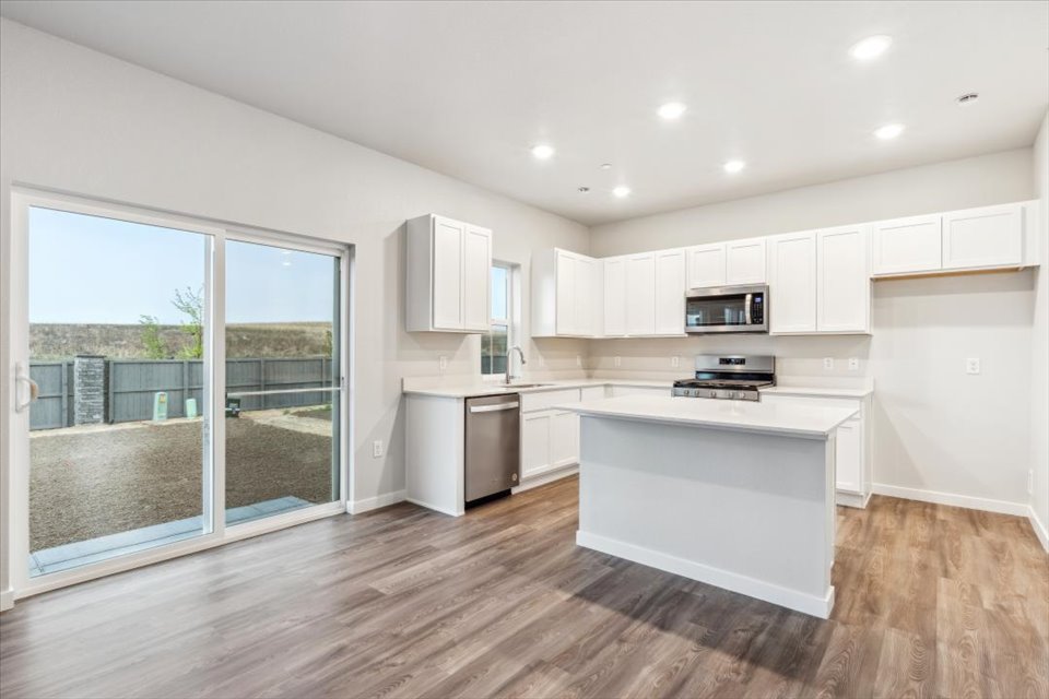 A kitchen with white cabinets.