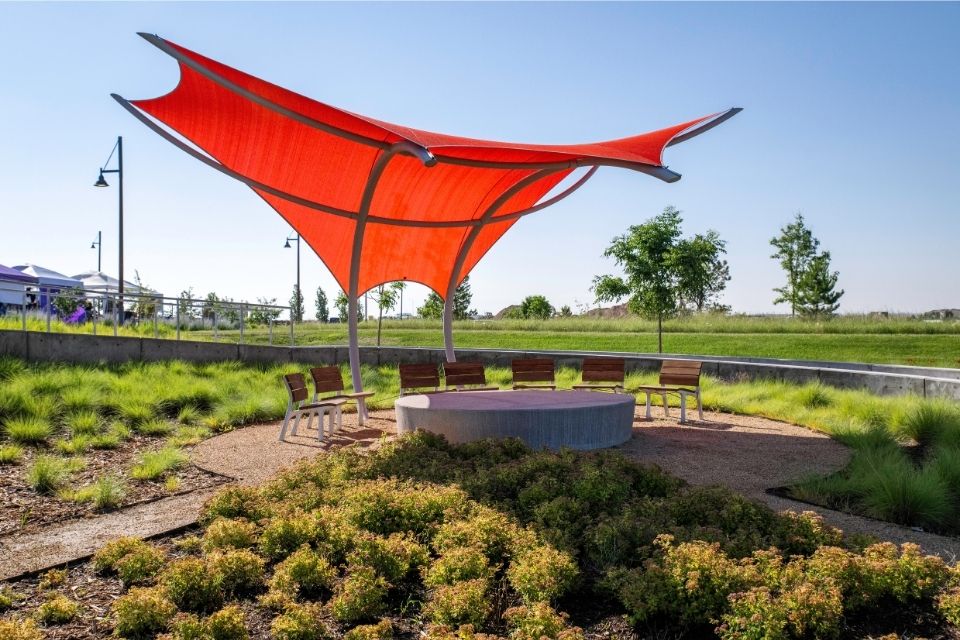 A large umbrella is placed over a park.