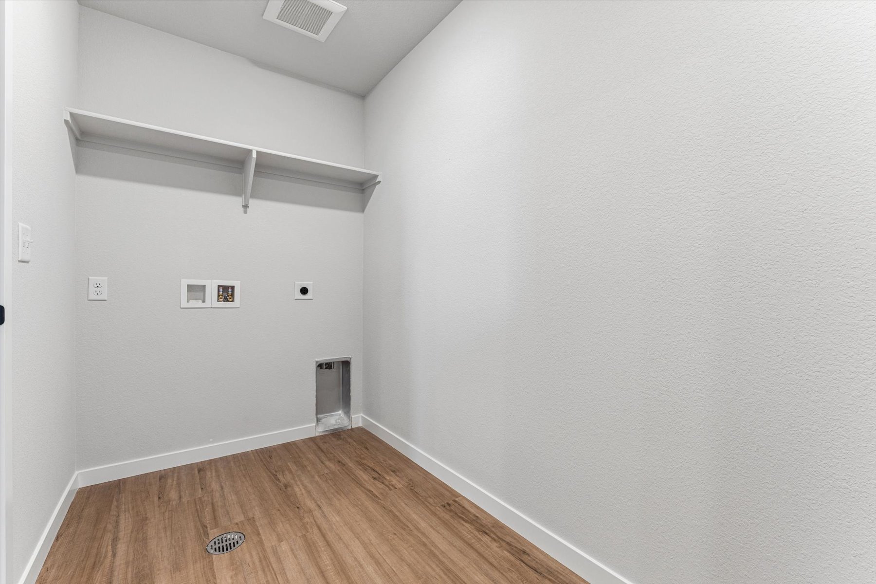 A room with a wood floor and white walls.