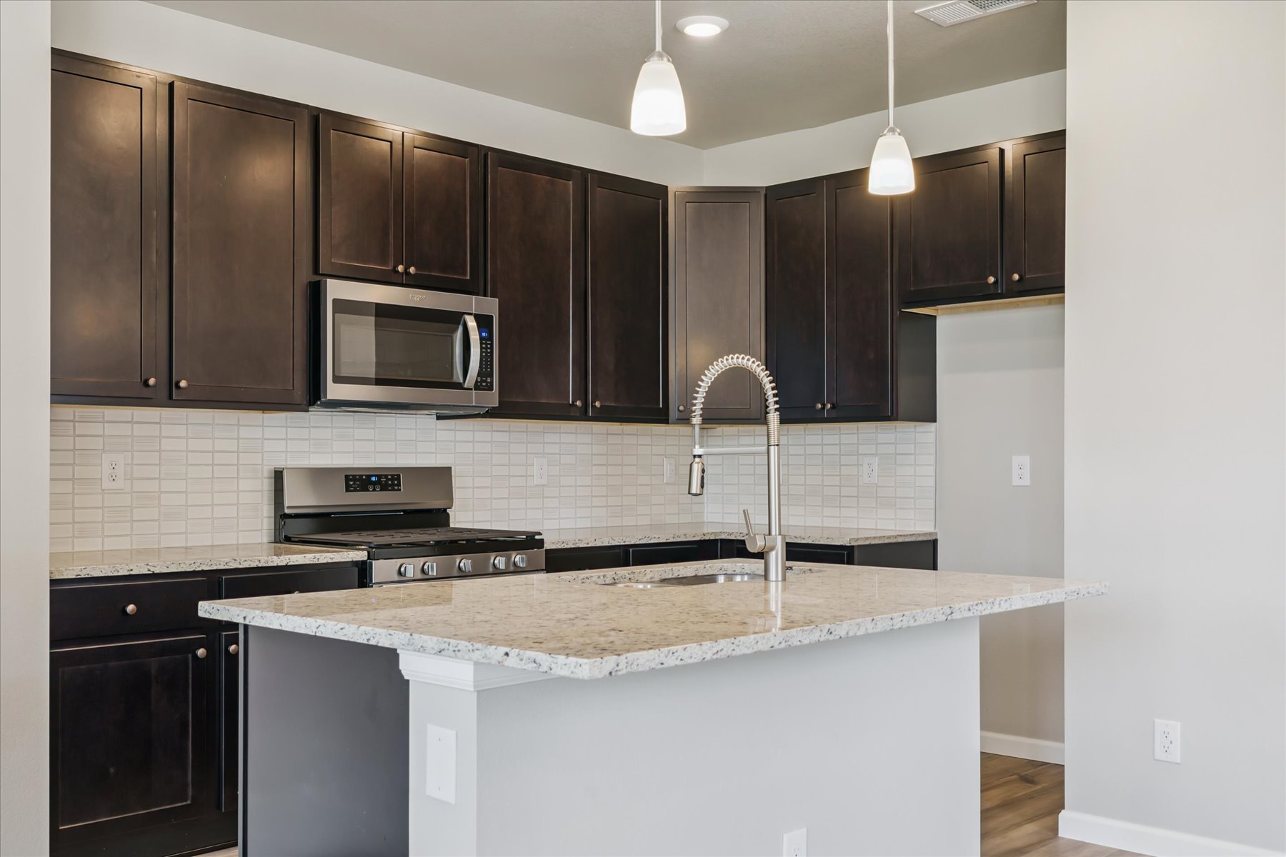 A kitchen with black cabinets.