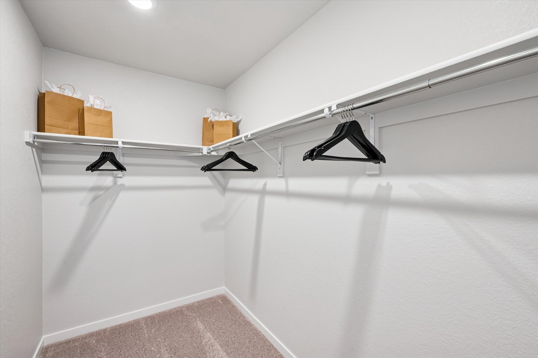 A white wall with a black lamp.