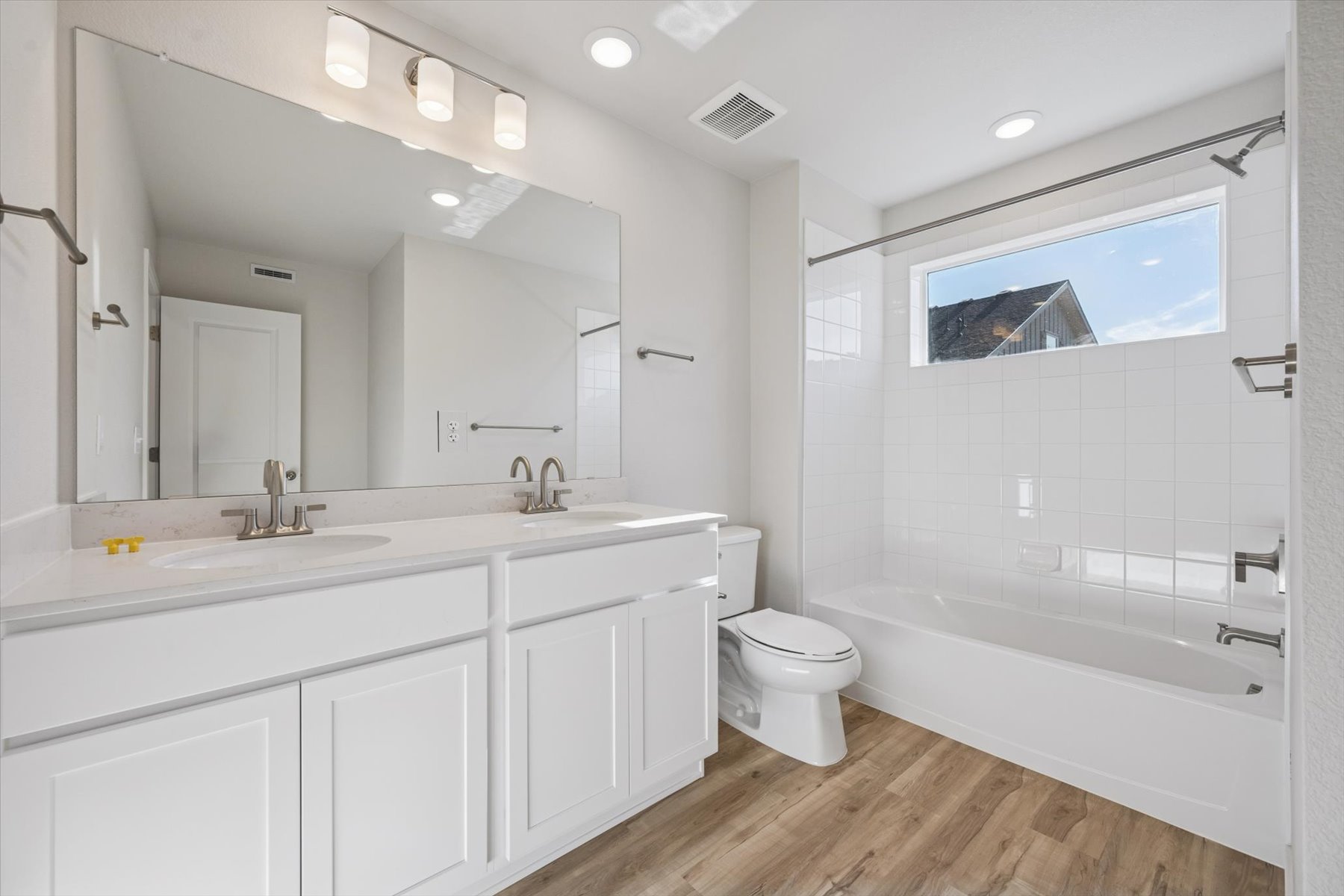 A bathroom with a tub toilet and sink.
