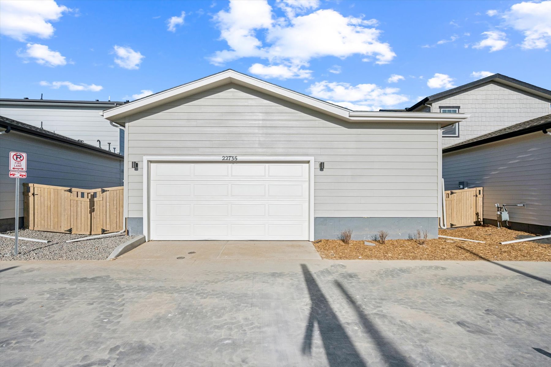A garage with a person's shadow on the ground.
