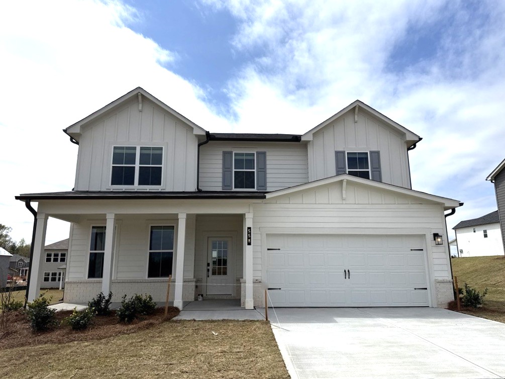 A white house with a garage.