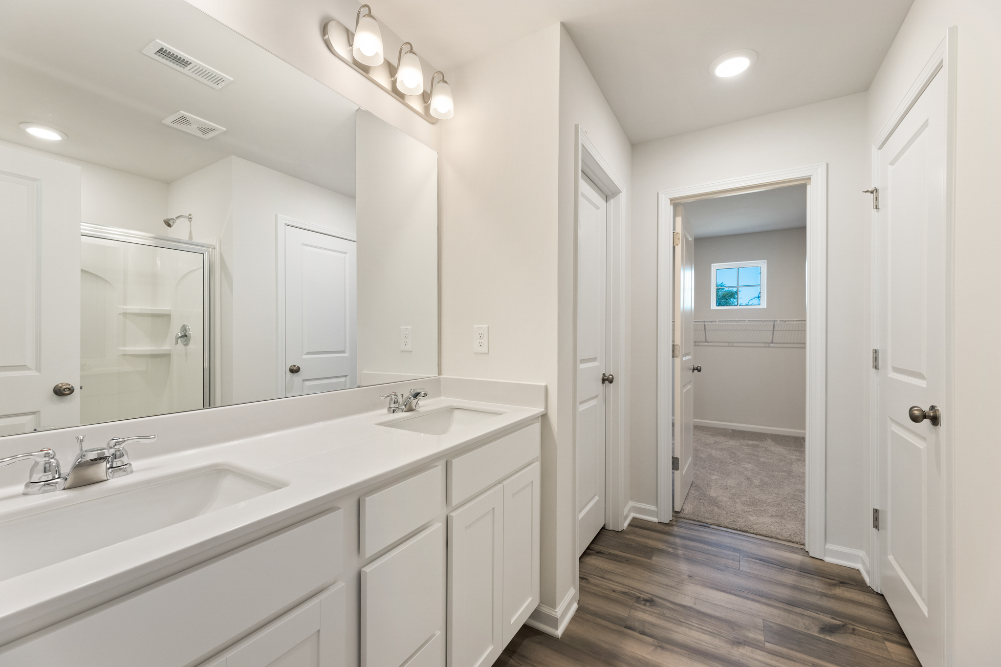 A bathroom with white cabinets.