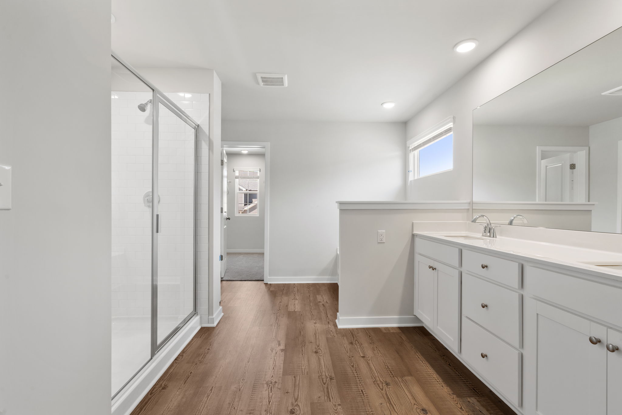 A bathroom with a wood floor.