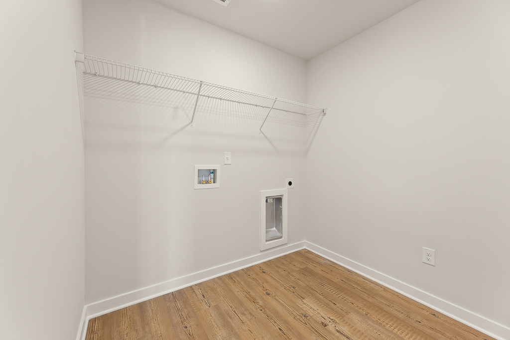 A white room with a wood floor.