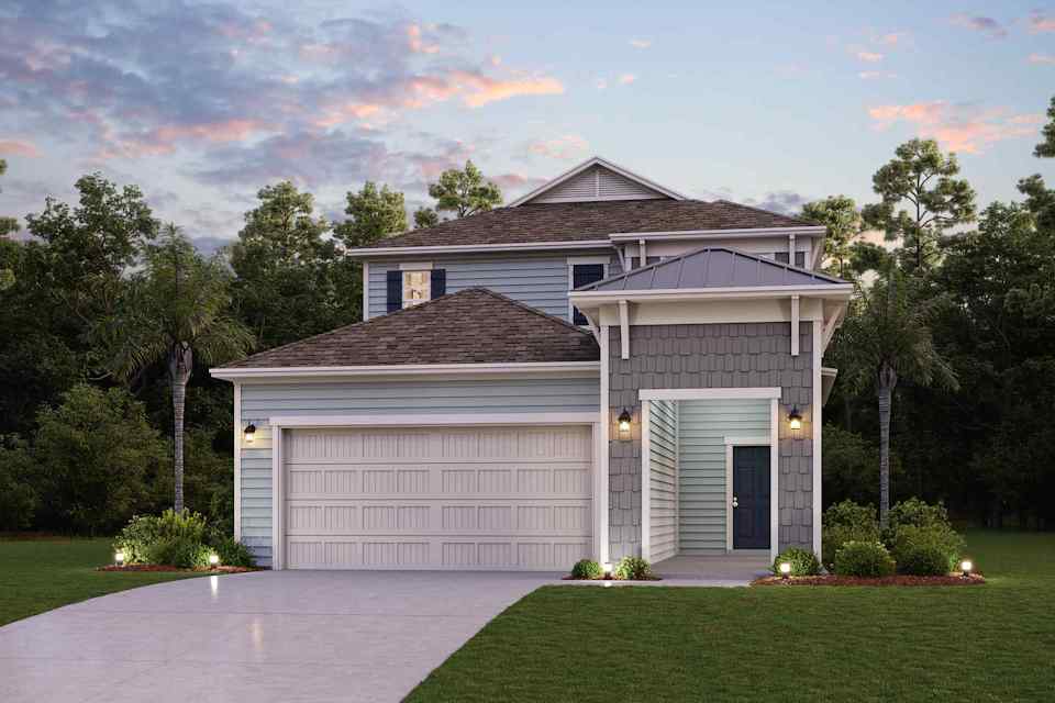A house with a garage and trees.