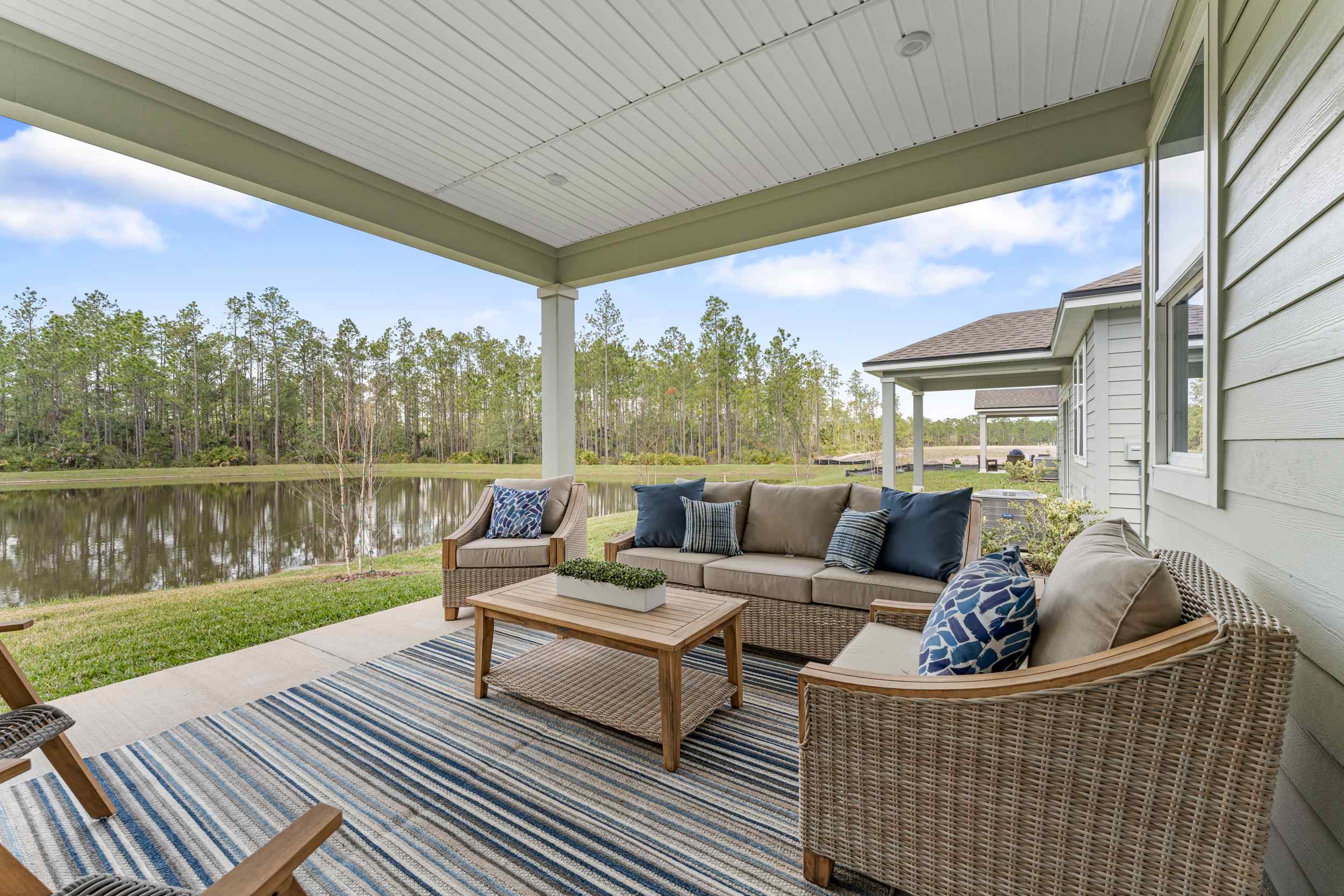 A deck with a pool and chairs.