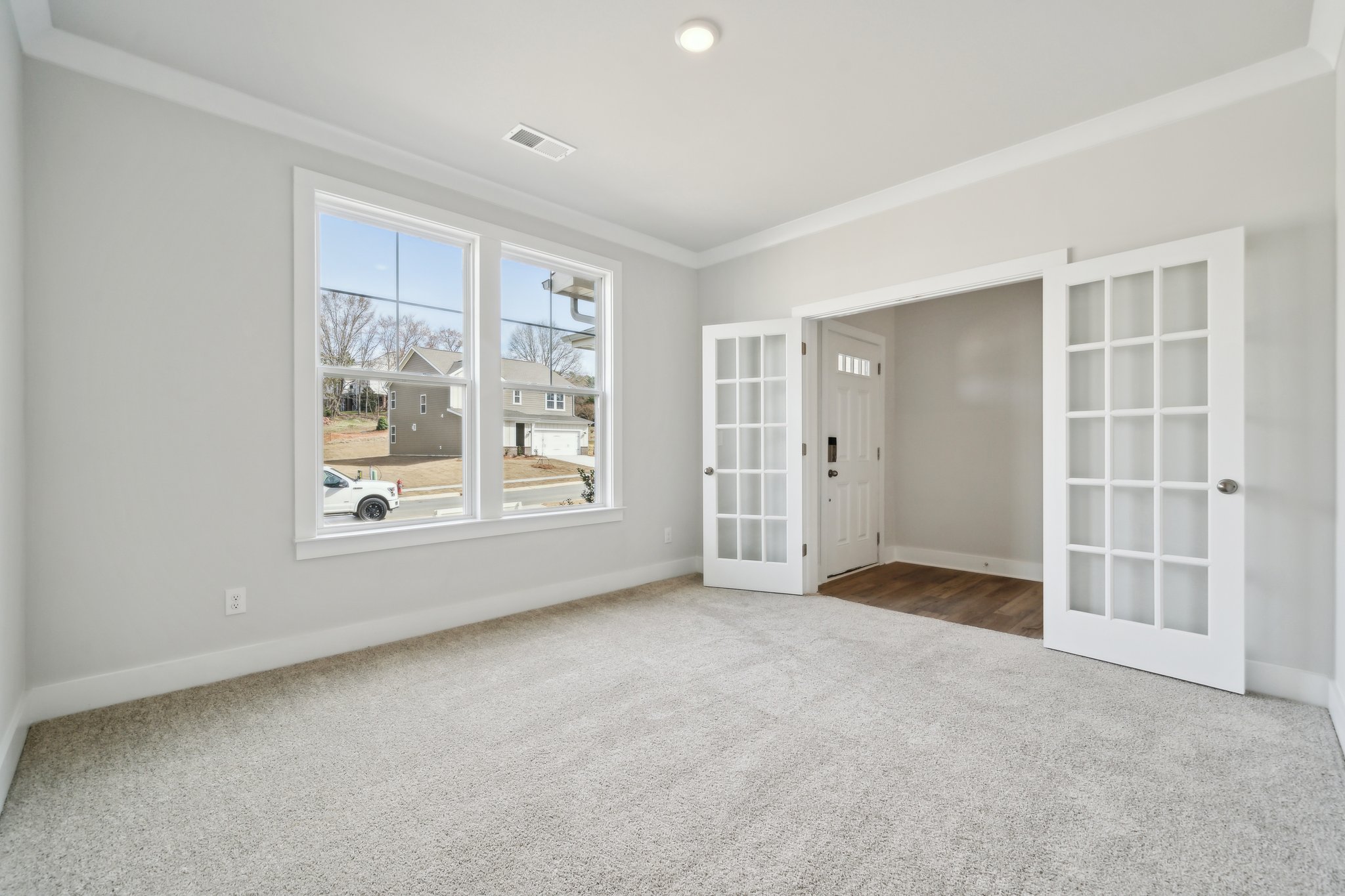 A room with a window and a door.