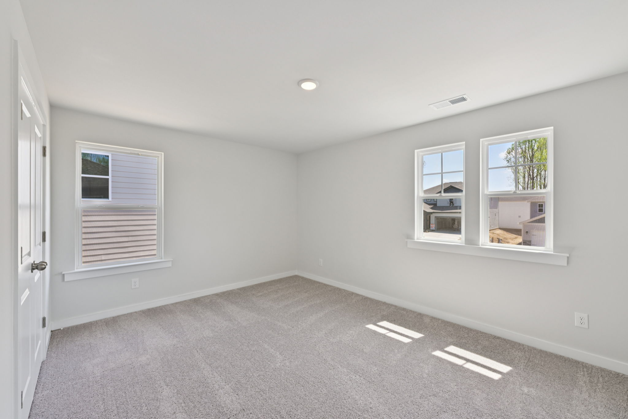 A room with a window and a door.