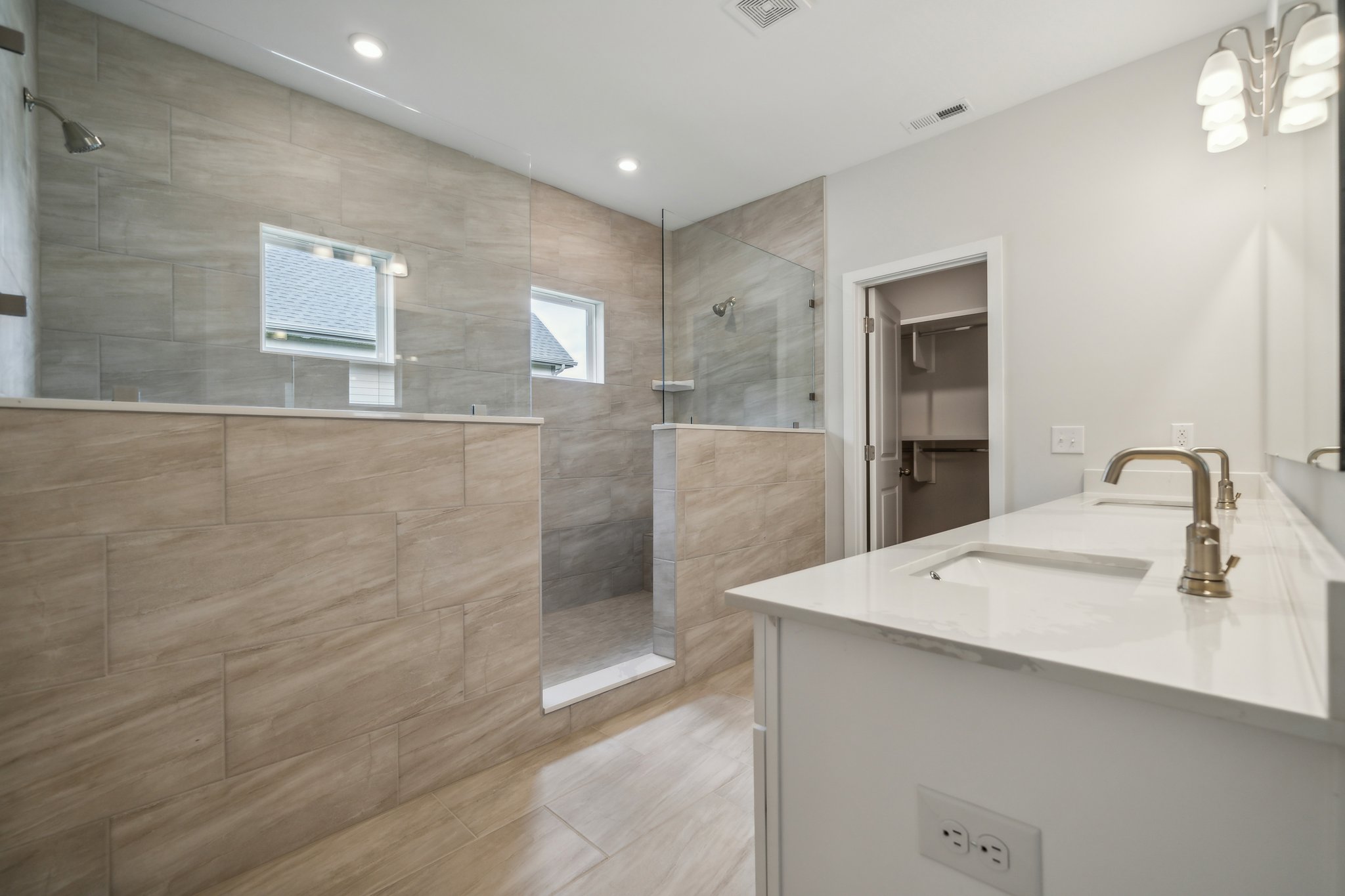 A bathroom with a large glass shower.