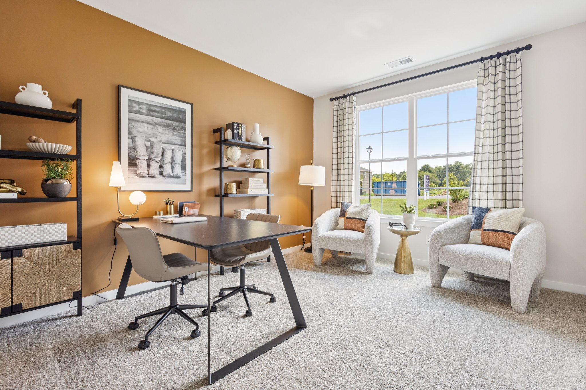 A room with a table chairs and a window.