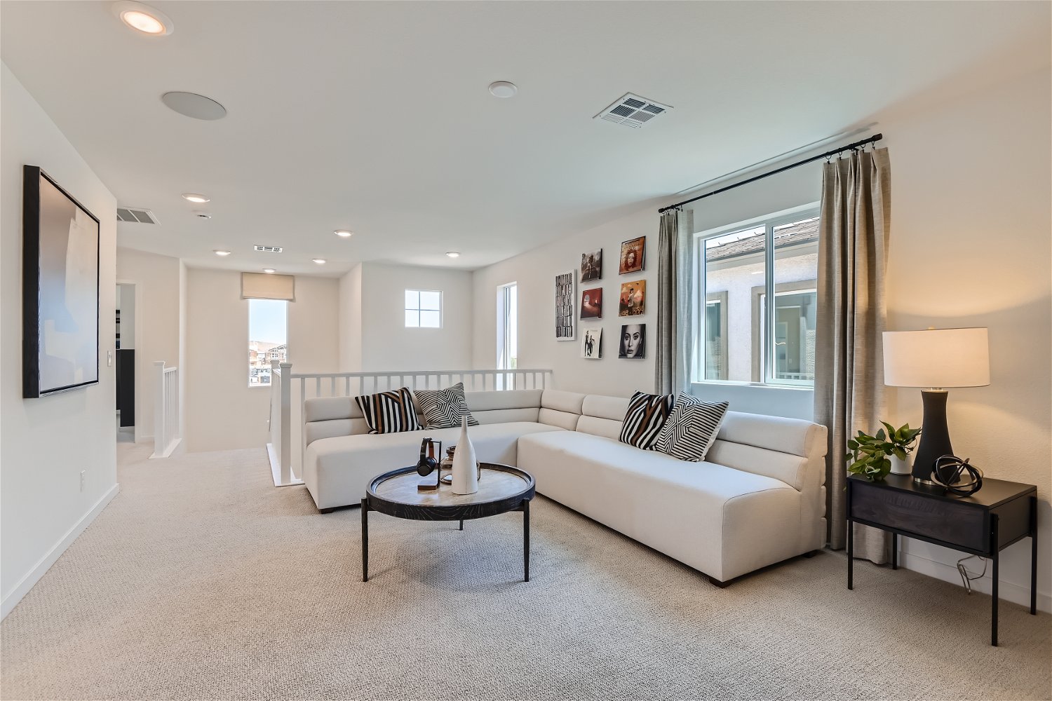 A living room with a white couch and a coffee table.