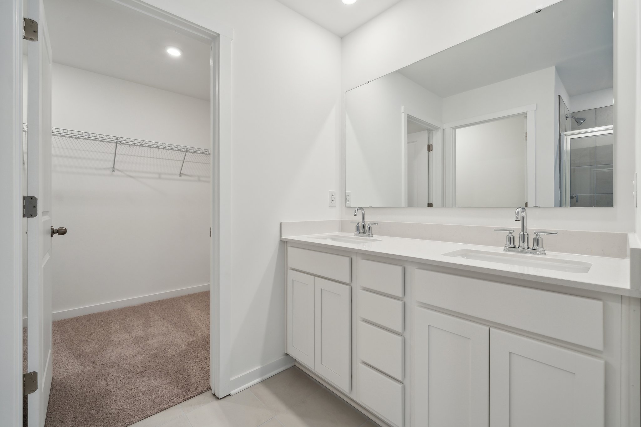 A bathroom with a sink and a shower unit.