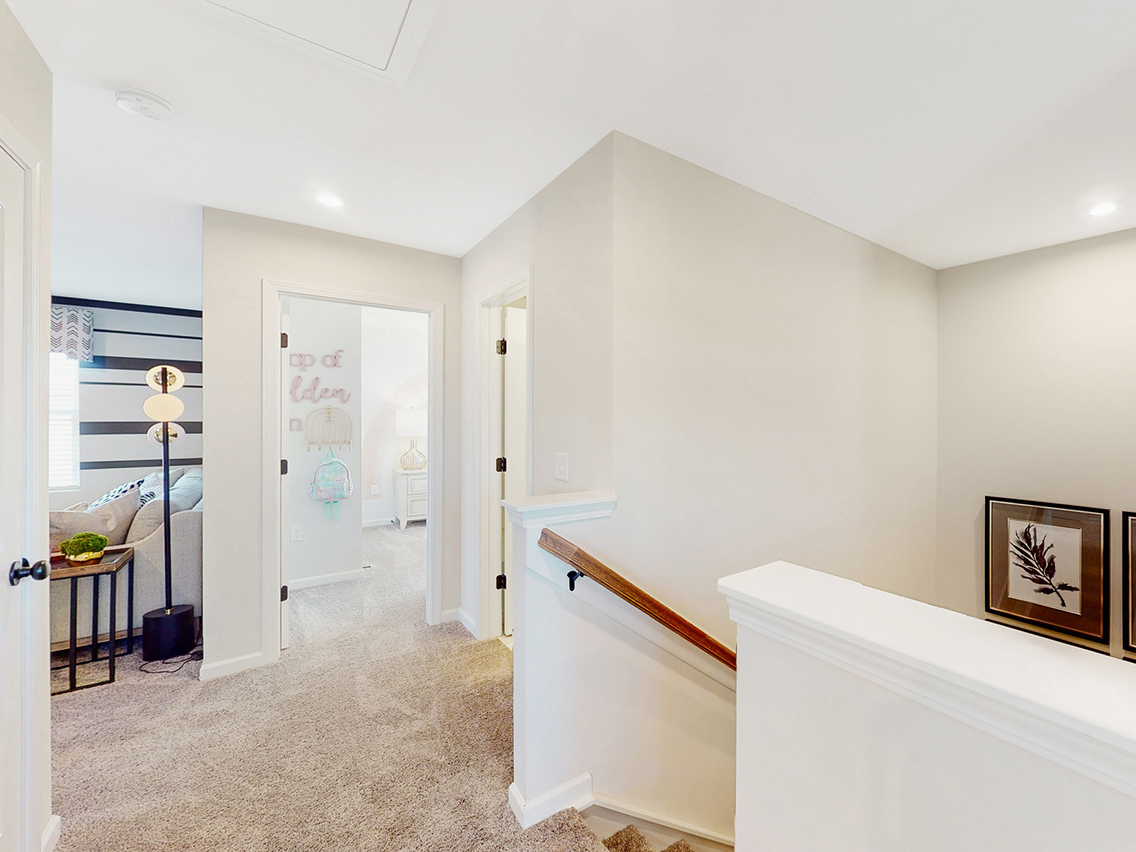 A room with a bed and a mirror.