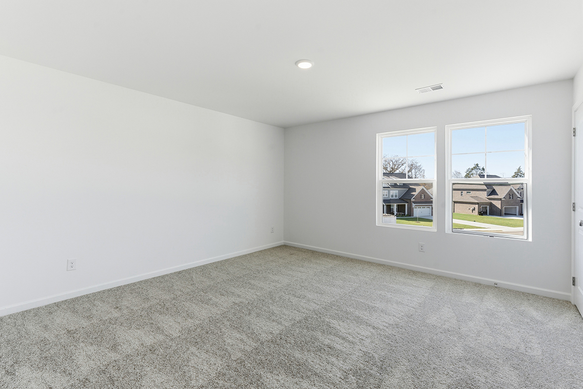 A room with a window and a carpet.