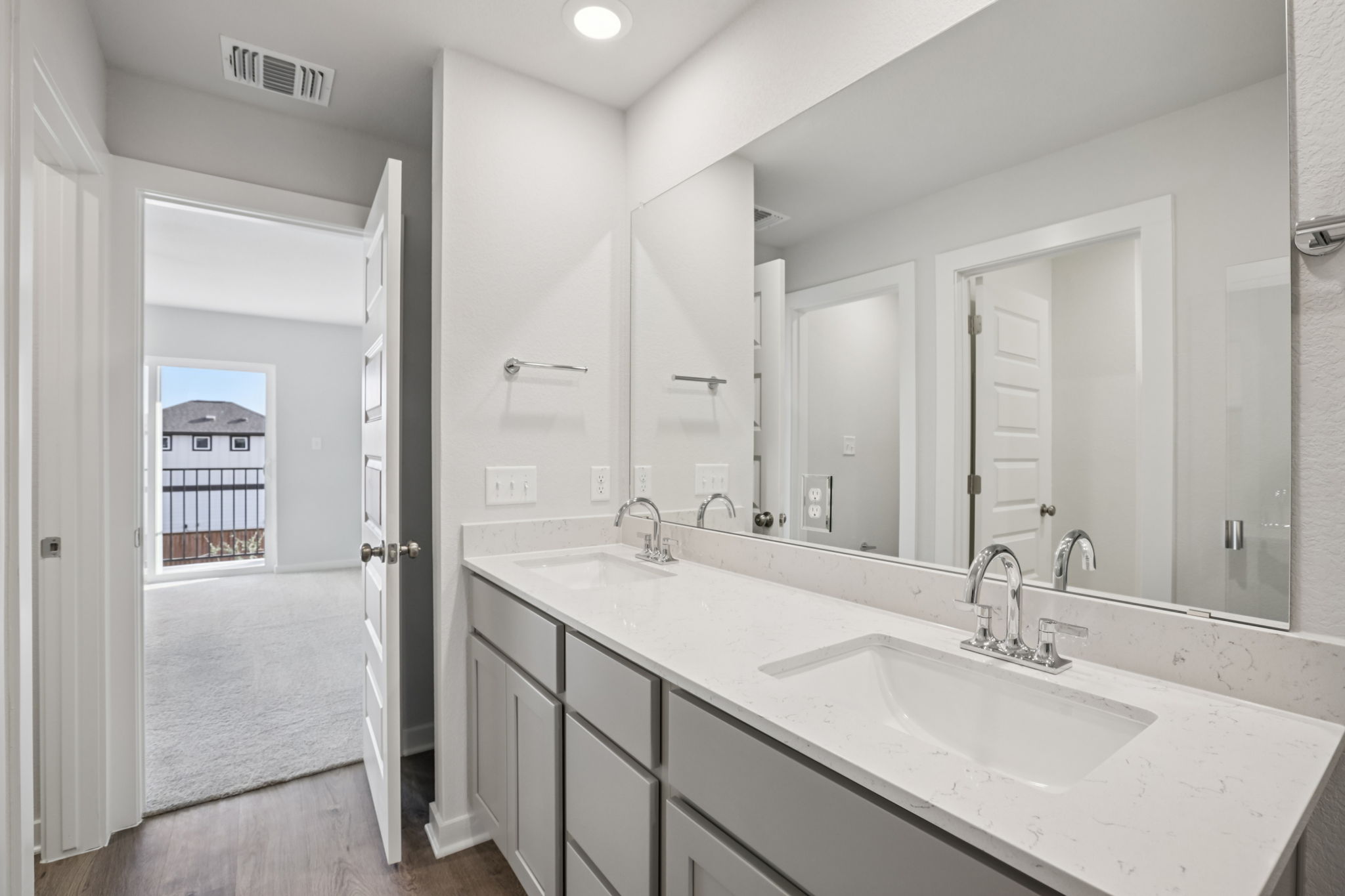A bathroom with a large mirror.