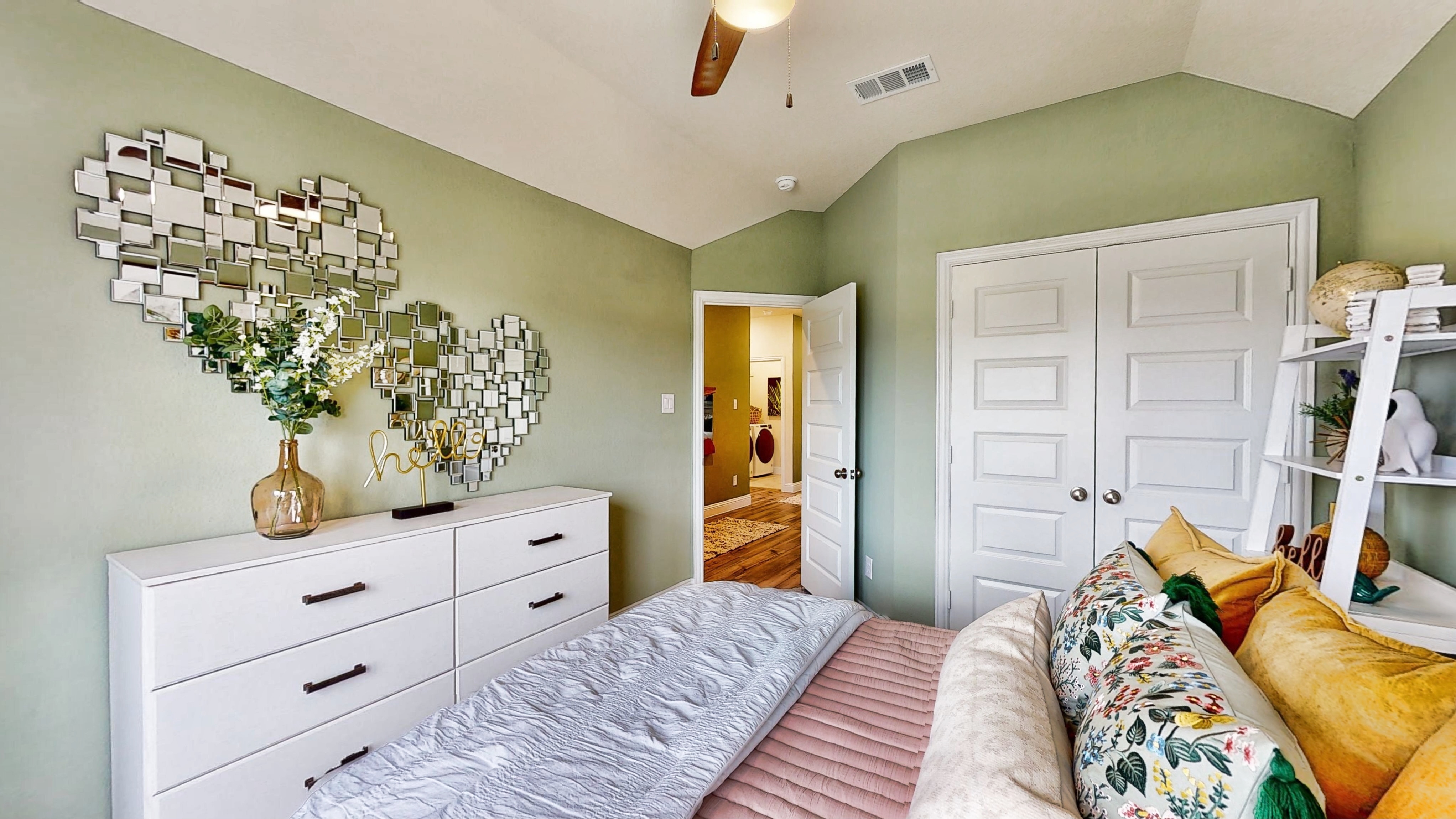 A bedroom with a bed and a dresser.
