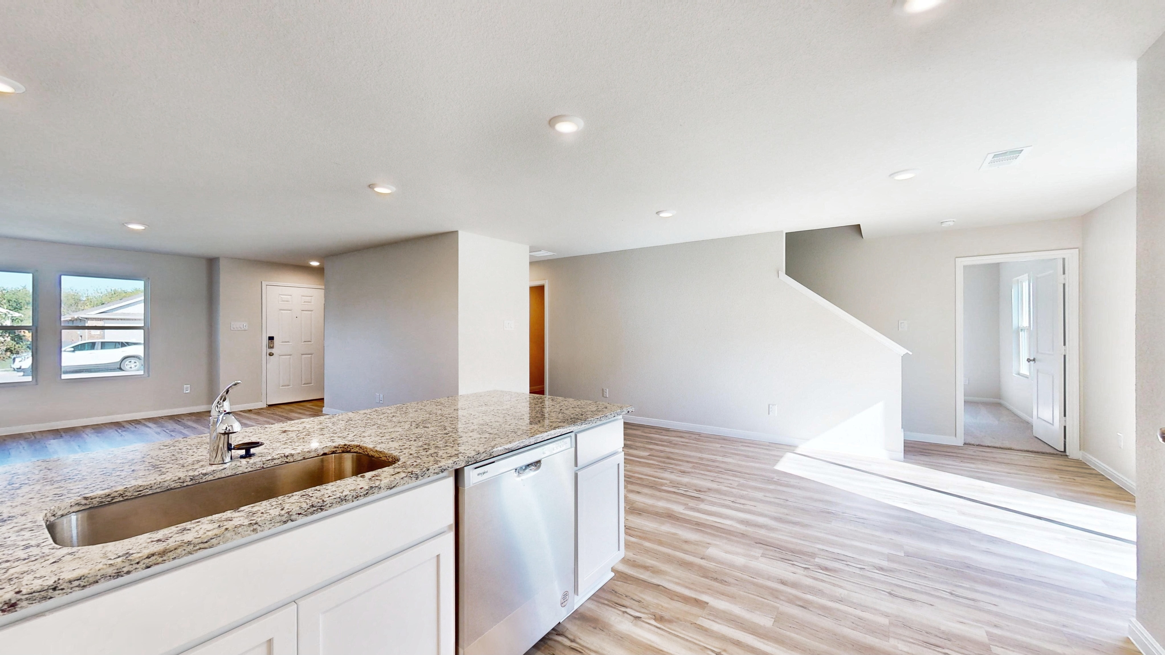 A kitchen with marble counters.