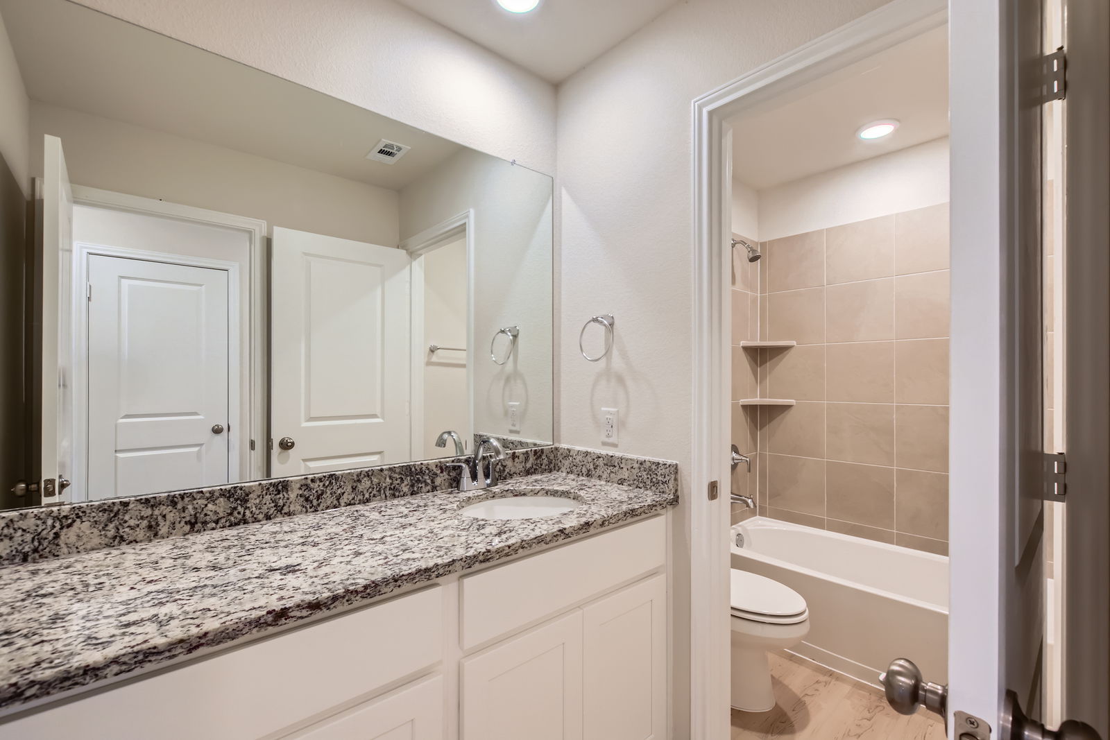 A bathroom with a marble countertop.