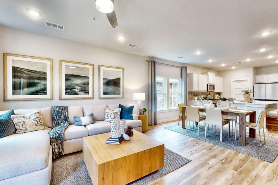 A living room with a dining table and couches.