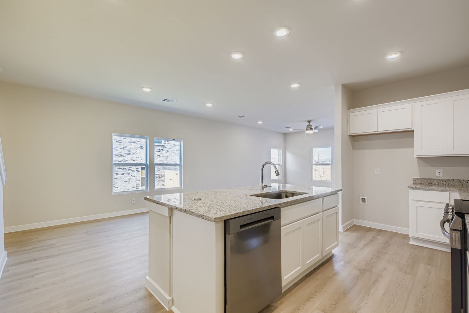 A kitchen with white cabinets.