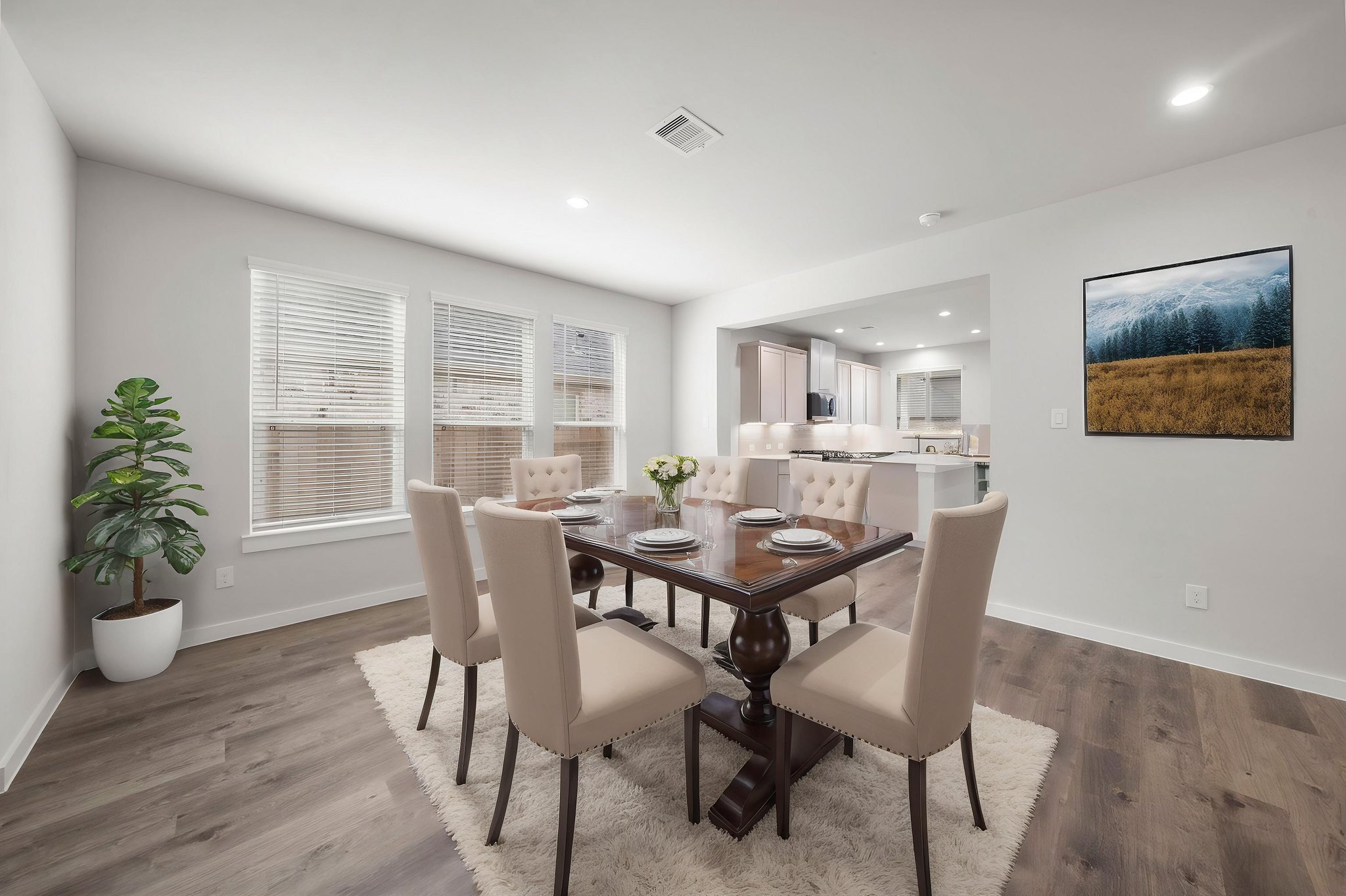 A dining room with a table and chairs.