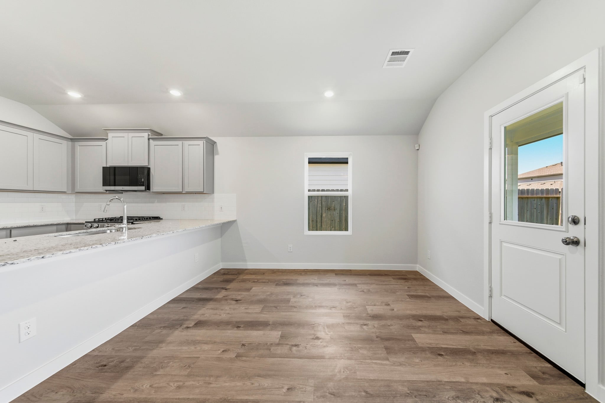 A kitchen with white walls.