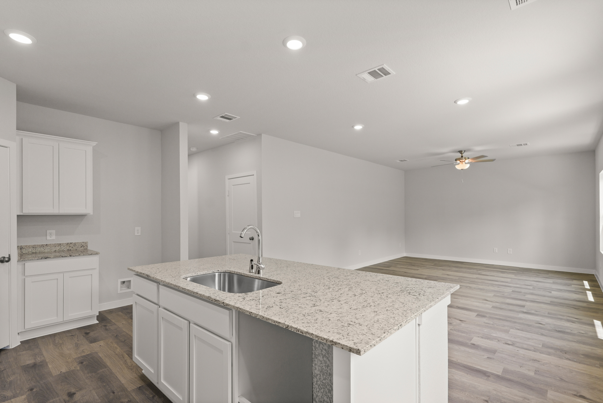 A kitchen with white cabinets.
