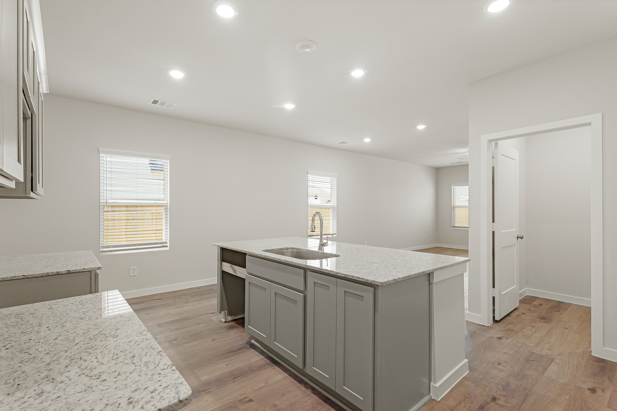A kitchen with marble counters.
